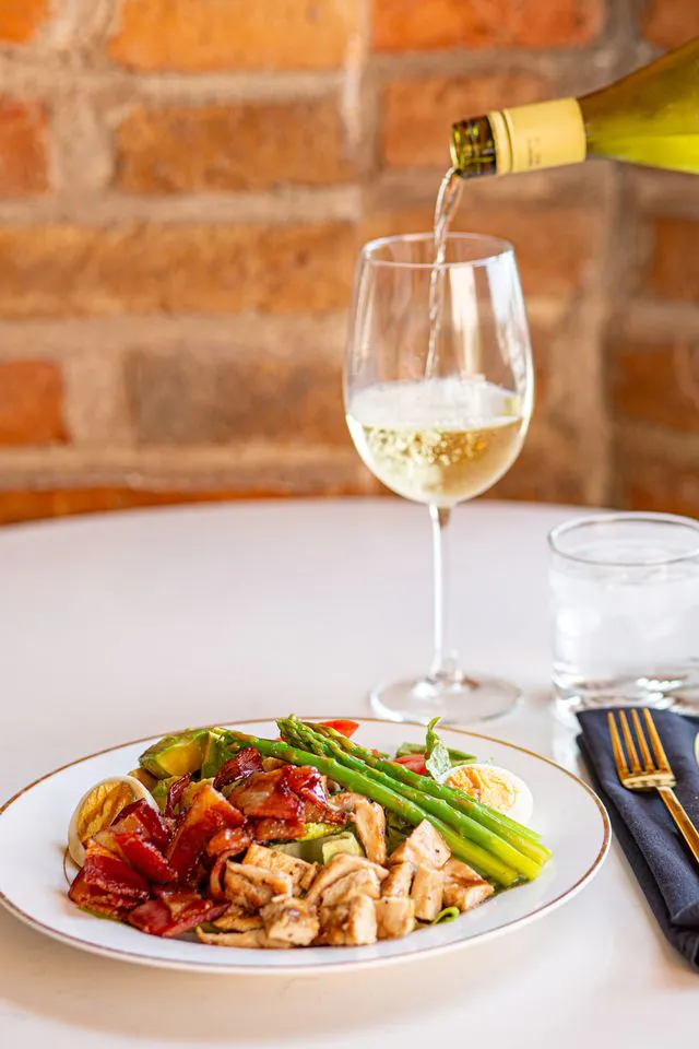 White wine and a plated meal at La Ola Restaurant