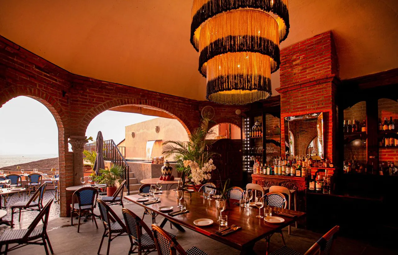 La Ola dining room with brick arches and hanging lamps