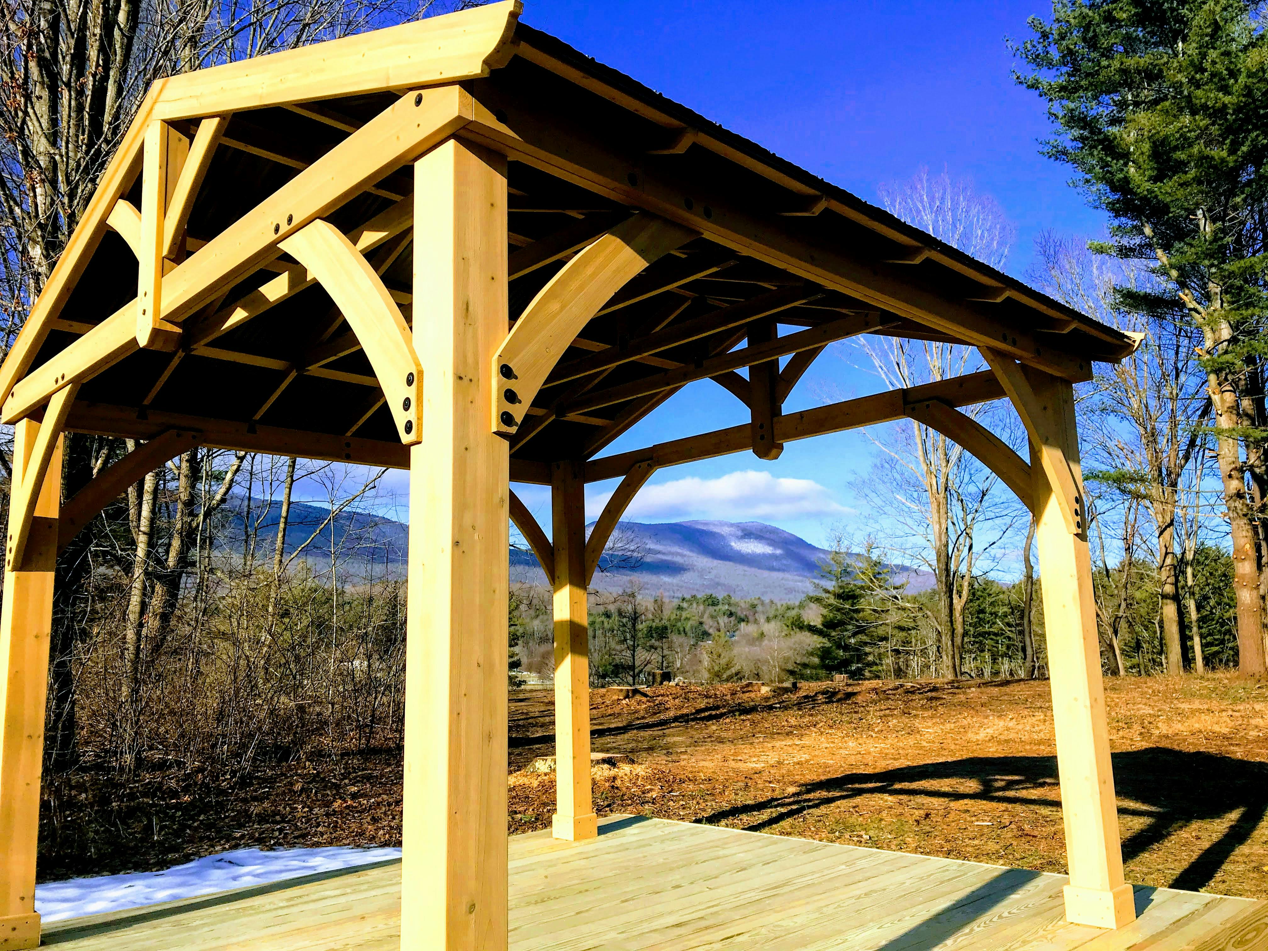 Image shows a wooden pavilion overlooking the mountains.