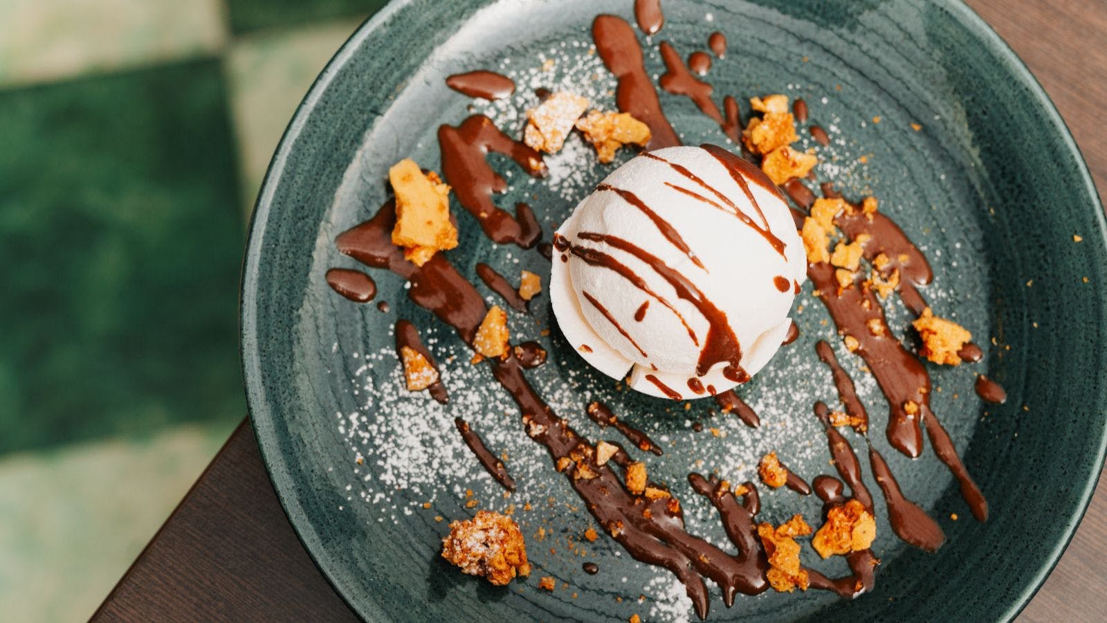 A delicious dessert on a plate, featuring chocolate and crumbs, served at Cabarfeidh Hotel.