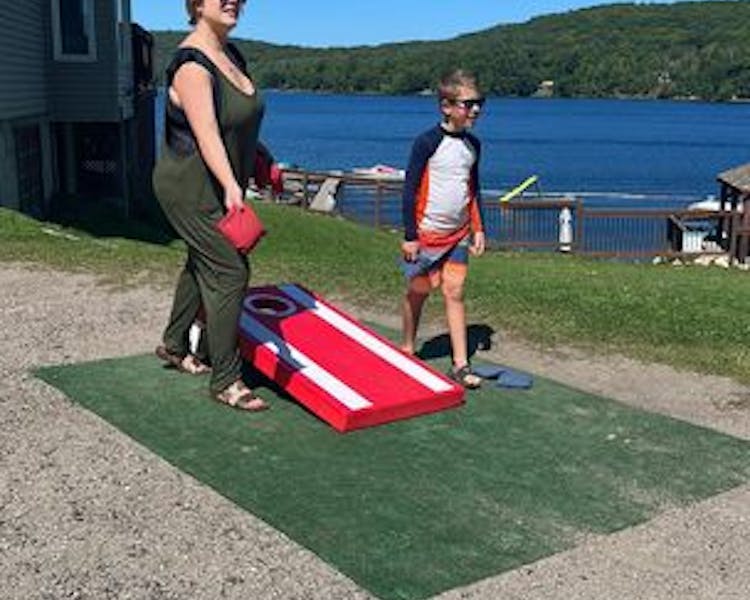 Family Fun at Dayspring Cottages - Mom and Son Playing Cornhole Together