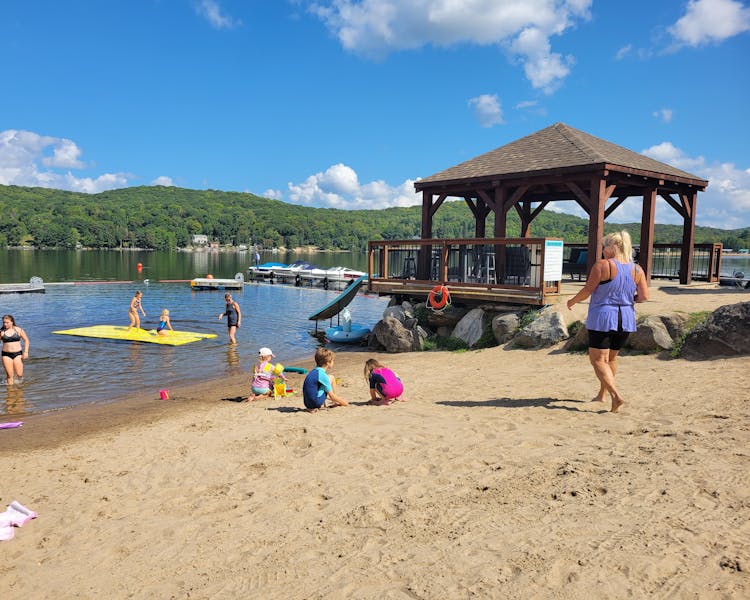Family at the beach on doe lake.Kid-Friendly Beach Play at Dayspring Cottages - Little Girls Enjoying Sand and Sun