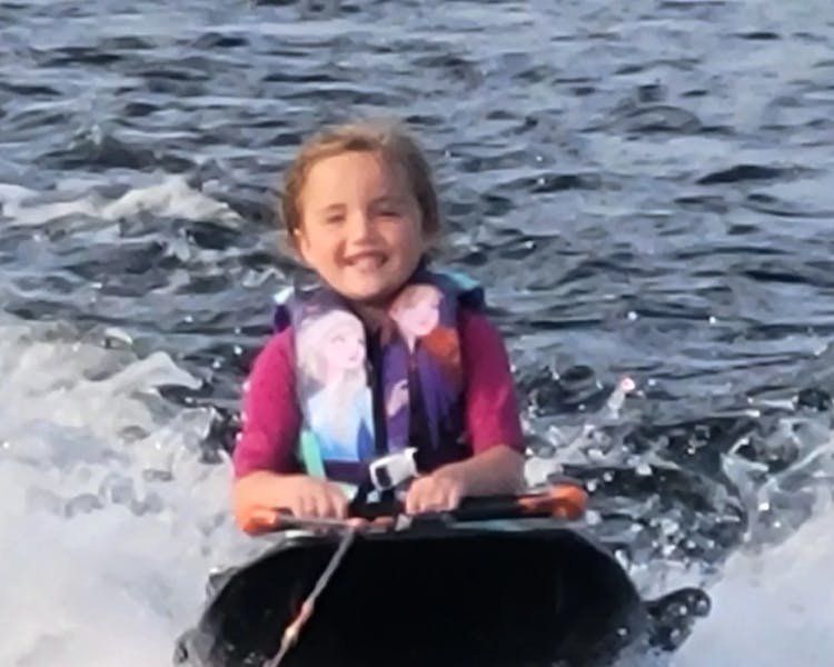 Kid-Friendly Water Activities at Doe Lake - Little Girl Knee Boarding with Dayspring Cottages Experience"