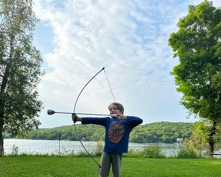 Kid-Friendly Activities at Dayspring Cottages - Young Archer Enjoying Bow and Arrow Fun