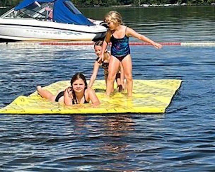 Sisters Having Fun on a Lily Pad at Dayspring Cottages - Kid-Friendly Water Play