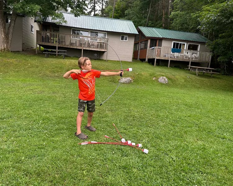 Kid-Friendly Activities at Dayspring Cottages - Young Archer Enjoying Bow and Arrow Fun