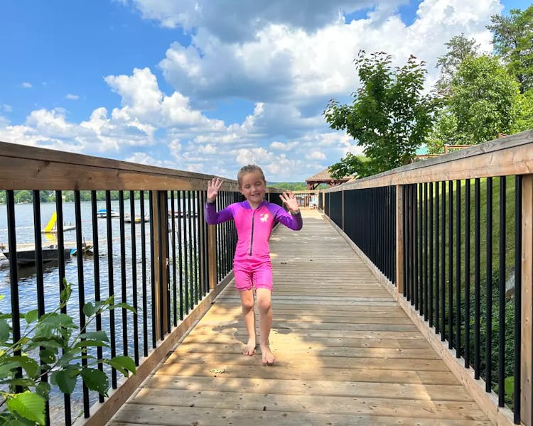 Kid-Friendly Boardwalk at Dayspring Cottages - Little Girl Enjoying Waterfront Scenic View"