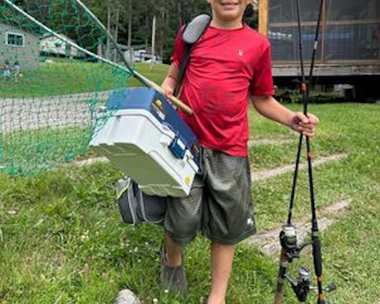 Kid-Friendly Fishing Cottages in Ontario - boy Holding a Fish at DaySpring Cottages