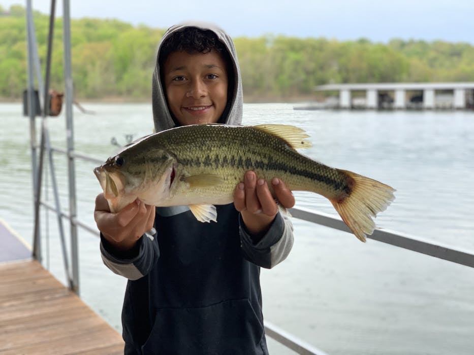 boy fishing holding large mouth bass table rock lake fishing