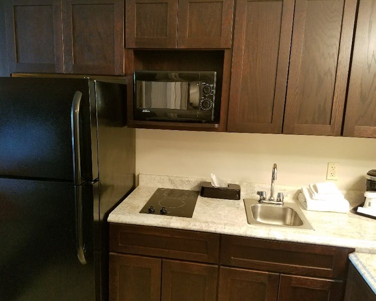 54 Extended Stay Suites with fridge & ice maker, two burner stove top, and microwave.