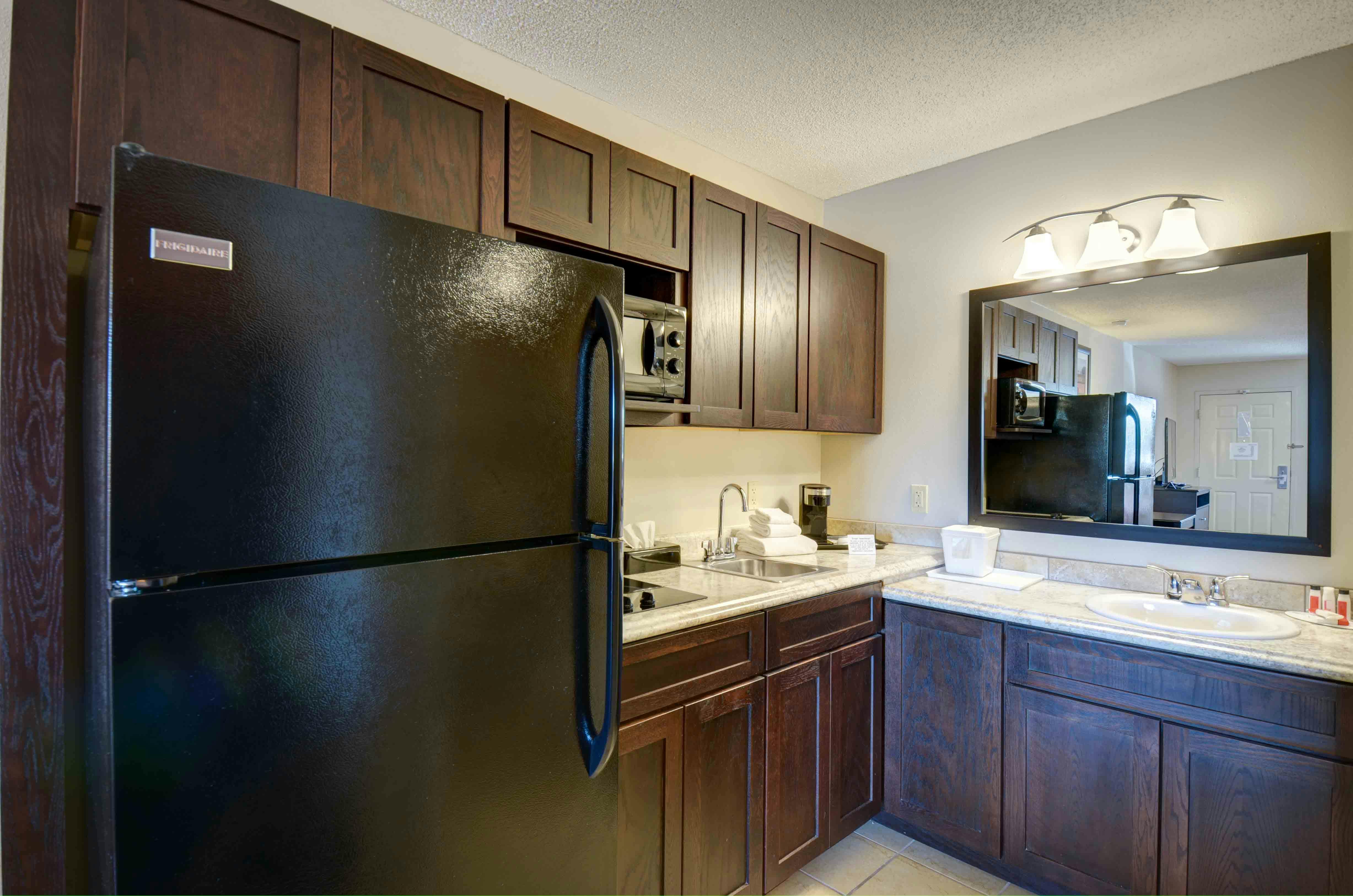 54 Extended Stay Suites with full size fridge with icemaker, two burner stove top, and microwave