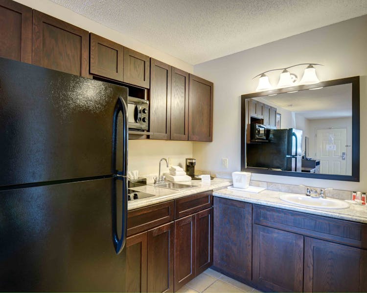 54 Extended Stay Suites with full size fridge with icemaker, two burner stove top, and microwave