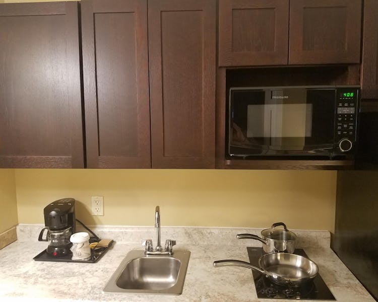 54 Extended Stay Suites with fridge & ice maker, two burner stove top, and microwave.