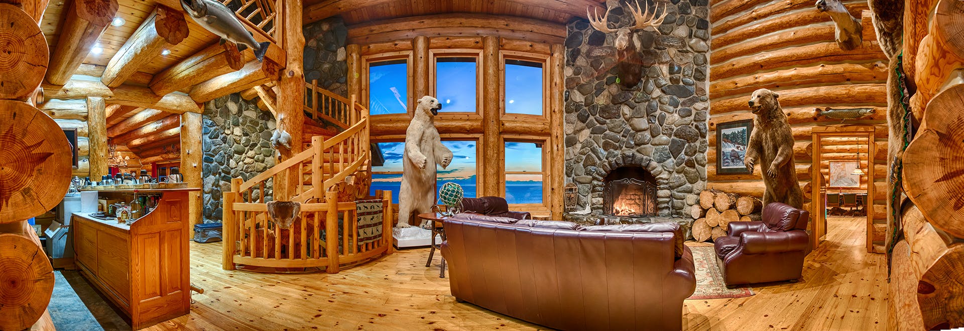 Panoramic views from alaska fishing lodge of the rock fireplace and standing bears and beyond, Mt Redoubt and Cook inlet