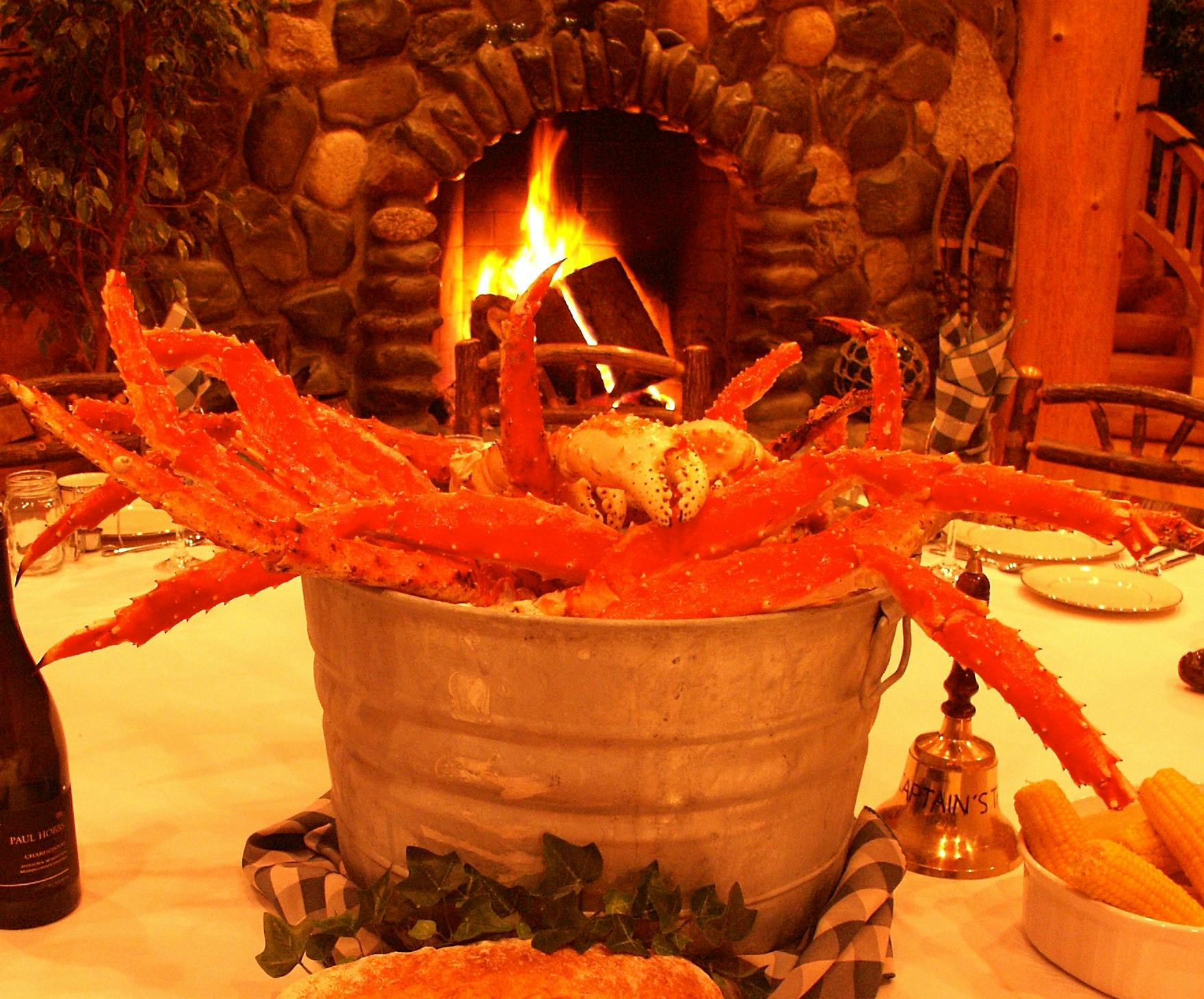 Opening dinner setting at Deep Creek Fishing Club with a pewter bucket filled with all-you-can-eat Alaskan King Crab legs.