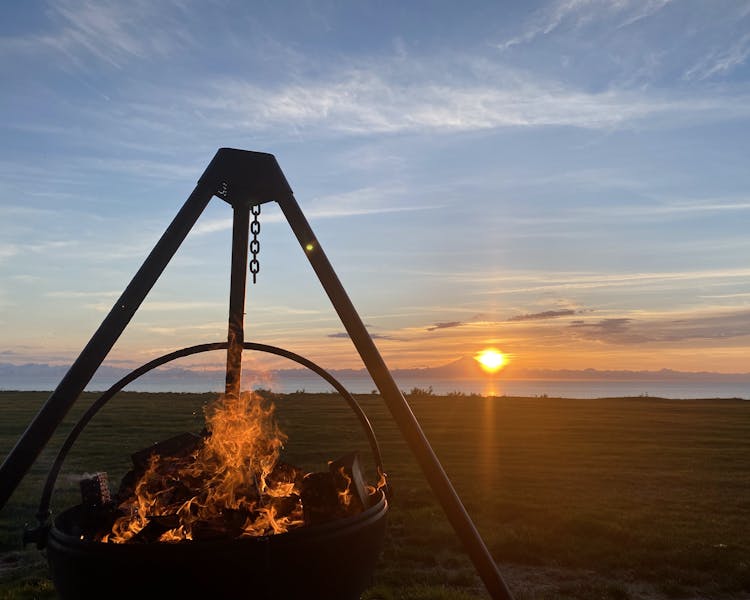 Our Cowboy cauldron alit with the sun setting in th background.