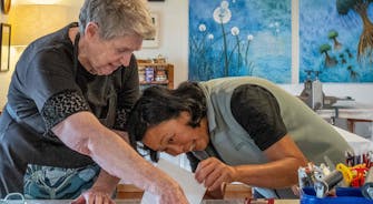 Two people engaged in contact printing. Image credit: Puddlehub 2024
