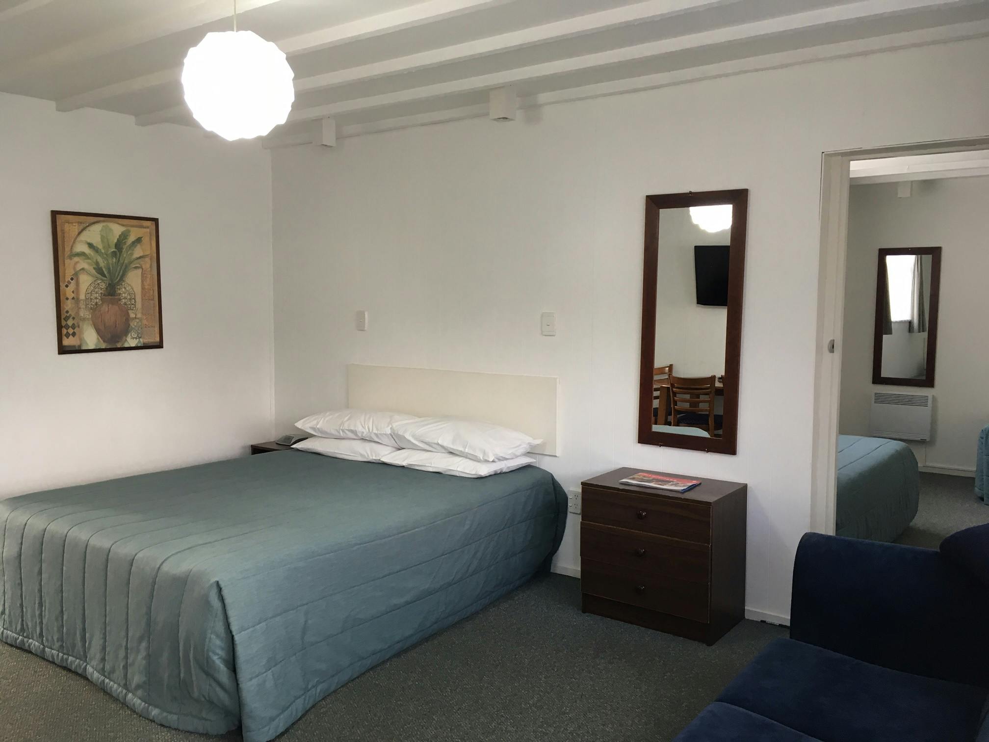 One-Bedroom Family Unit - 1 x queen bed in the lounge, 3 x single beds in a separate bedroom.