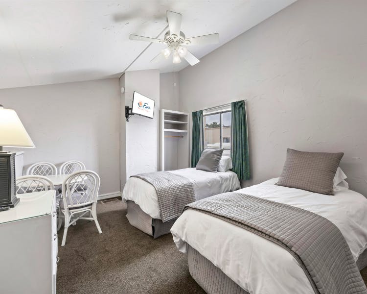 Loft bedroom with twin beds and tables and chairs at Sea Crest Surf & Racquet Club vacation condo
