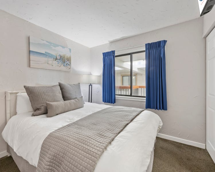 Primary bedroom with king bed at Sea Crest Surf & Racquet Club resort