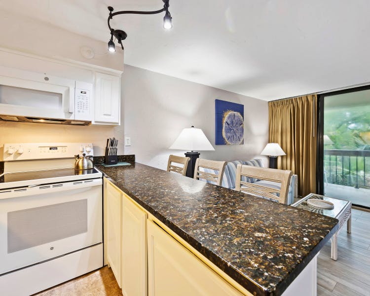 Breakfast Bar seating and granite countertops in updated kitchen at Sea Crest two-bedroom unit