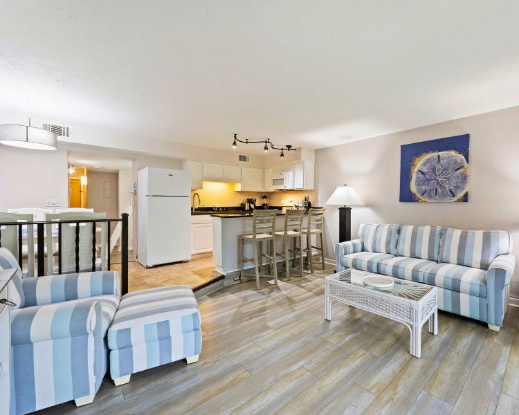 Open-concept living room and kitchen in two-bedroom vacation rental at Sea Crest Surf & Racquet Club Hilton Head Island