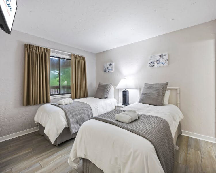 Bright guest bedroom with twin beds at Sea Crest Surf & Racquet Club two-bedroom condo