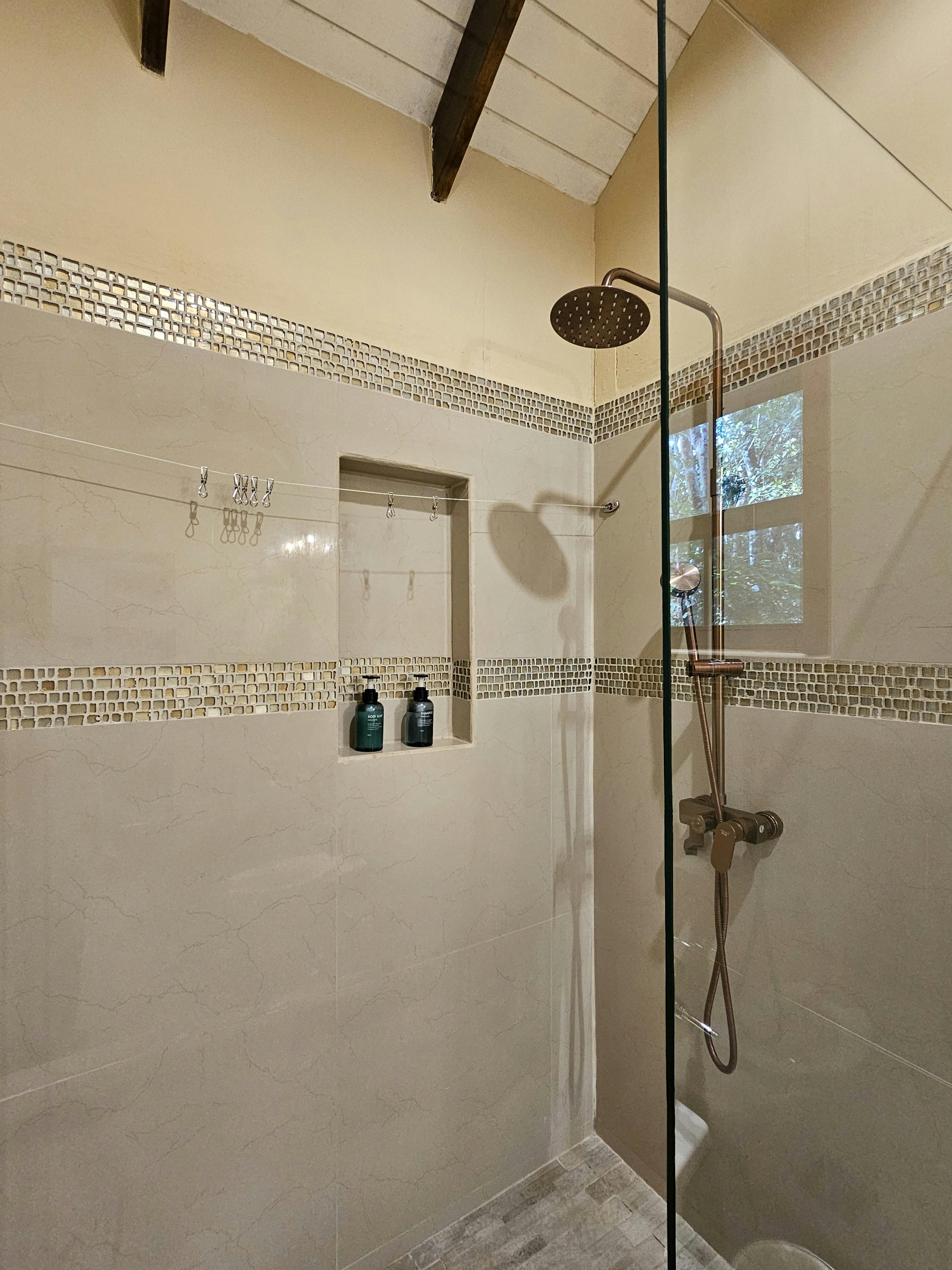 Shower area of bathroom of upper level bedroom of Tree House @ KikiWitz