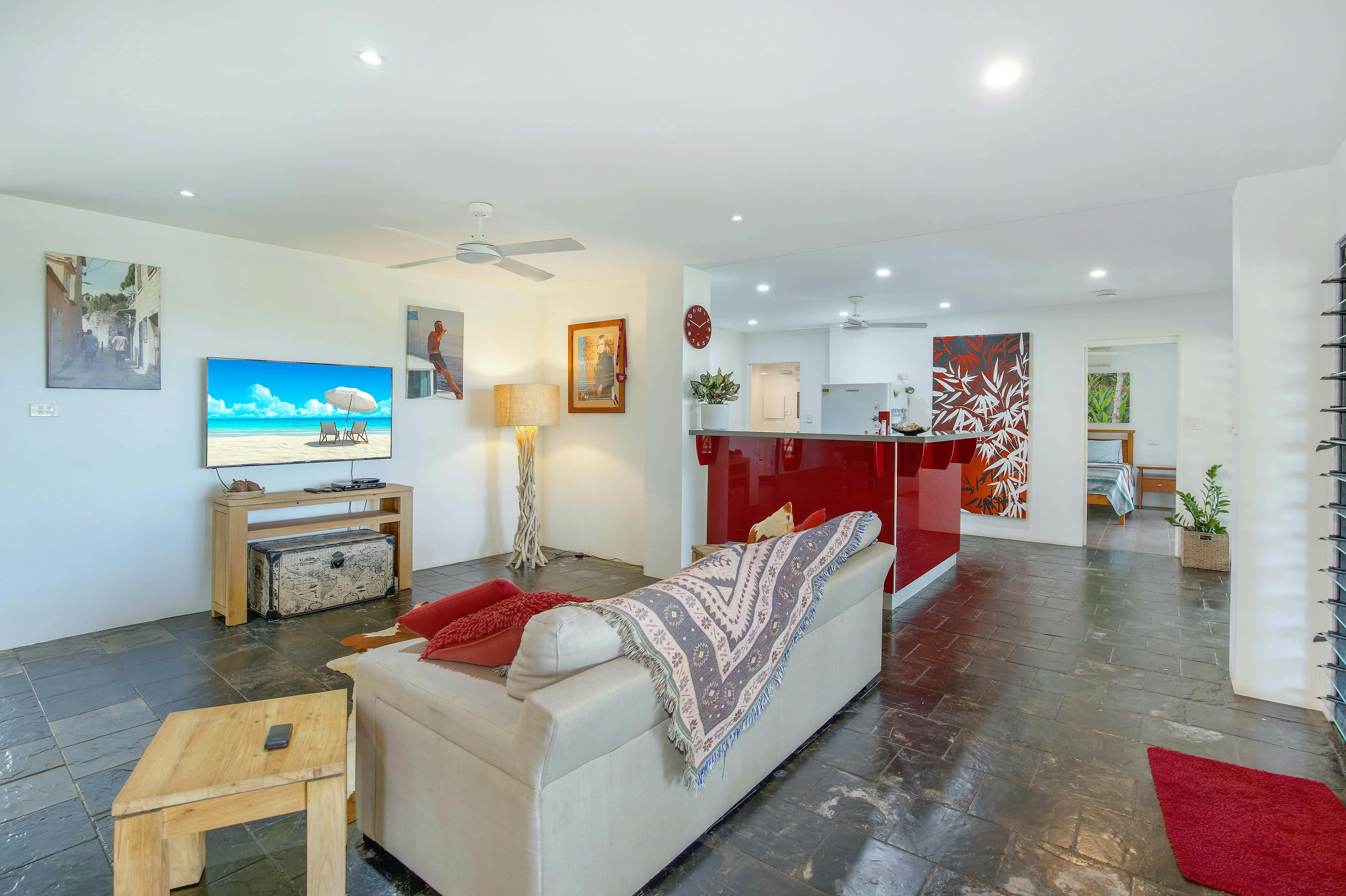 Comfortable Living Room with Smart TV and Kitchen