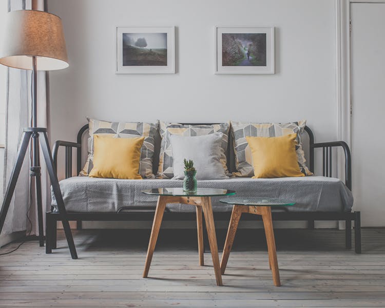 A stylish and unique decorated triple room with cozy lightning features and a sleeping couch