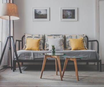 A stylish and unique decorated triple room with cozy lightning features and a sleeping couch