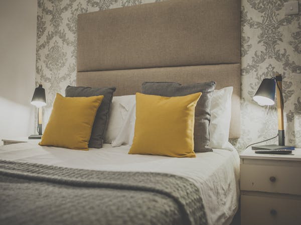 Pillows are on the bed of a beautifully decorated double room with ensuite in a cozy atmosphere