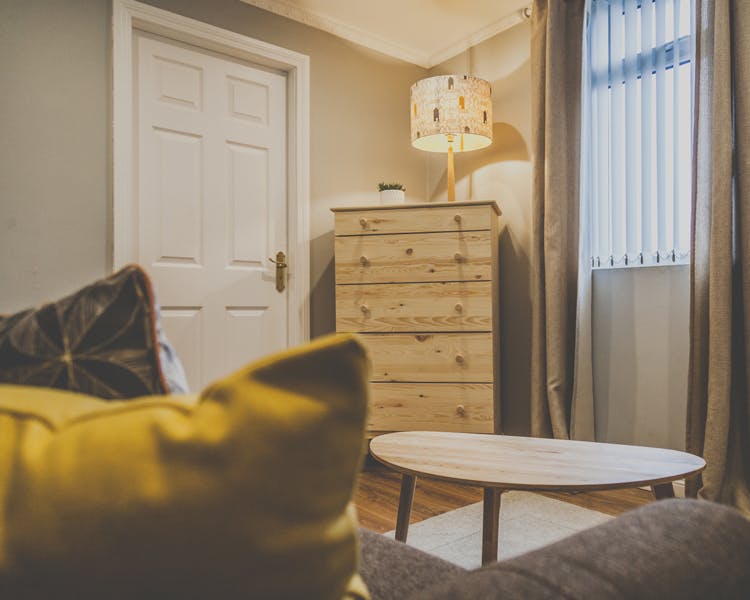 A beautifully decorated sitting area in a cozy atmosphere with table, couch and furniture