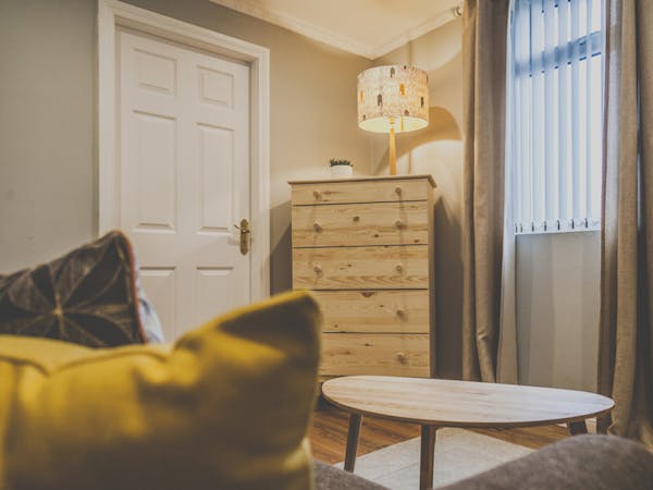 A beautifully decorated sitting area in a cozy atmosphere with table, couch and furniture