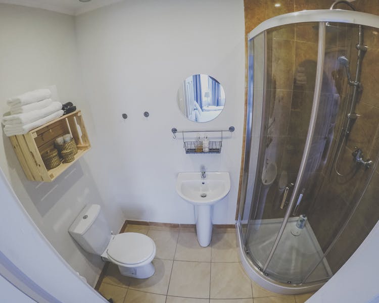 Ensuite bathroom with shower, sink and toilet. Towels and toiletries provided