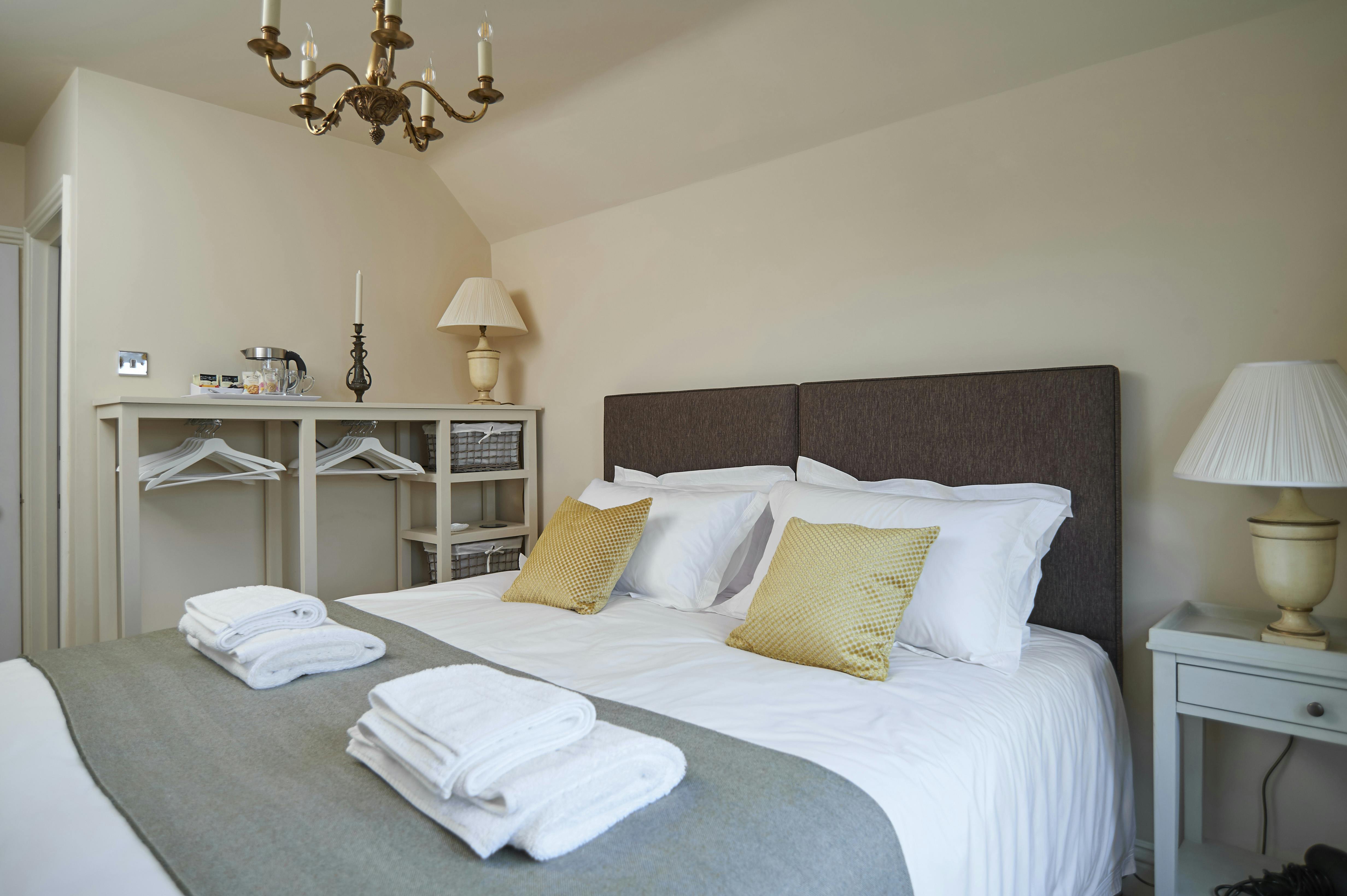 Twin Room as Superking bed with view of open wardrobe and tea/coffee tray.