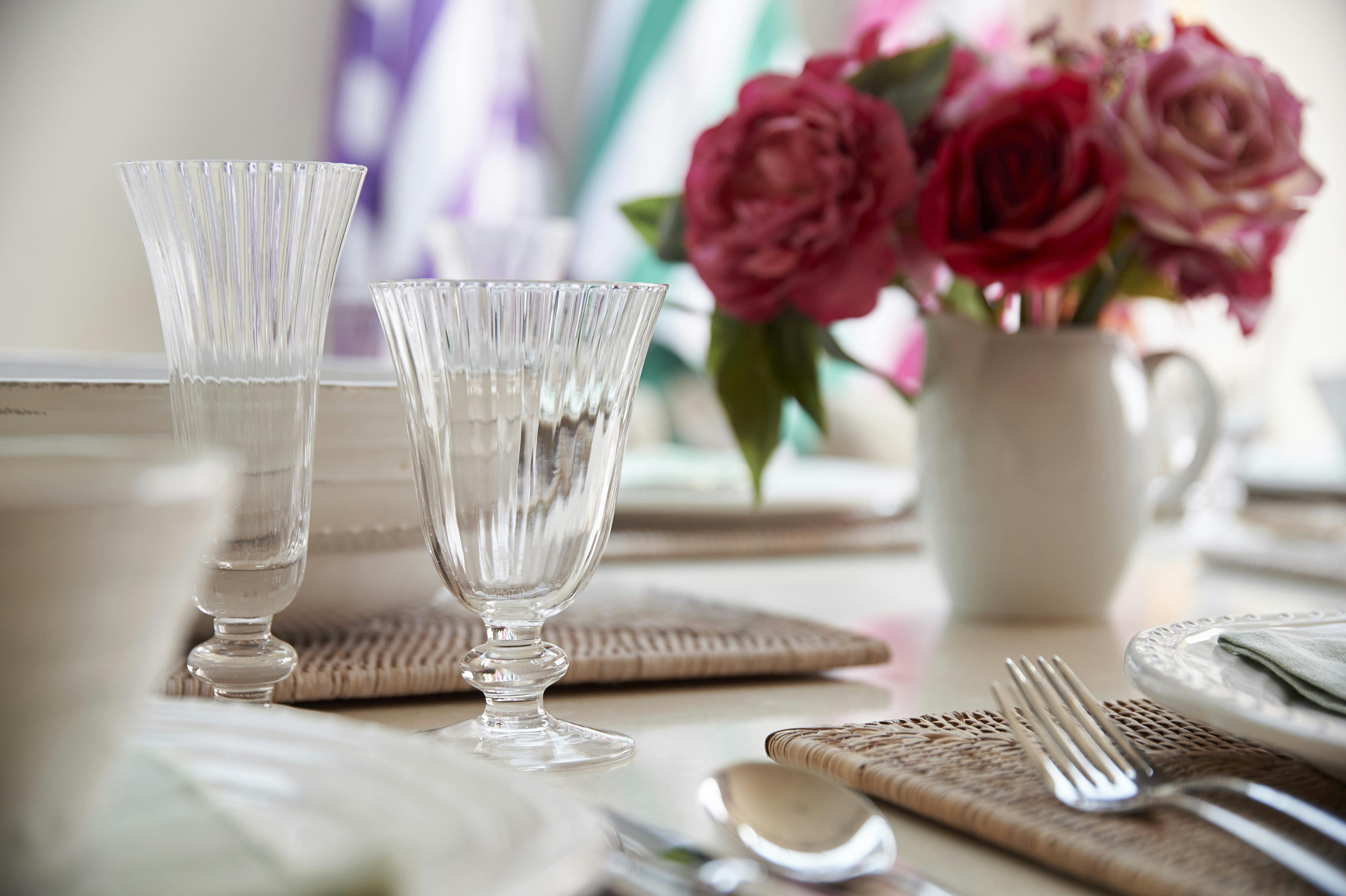 Dining Table laid with vintage style glasses, woven mats, Villeroy Boch cutlery and Neptune crockery.