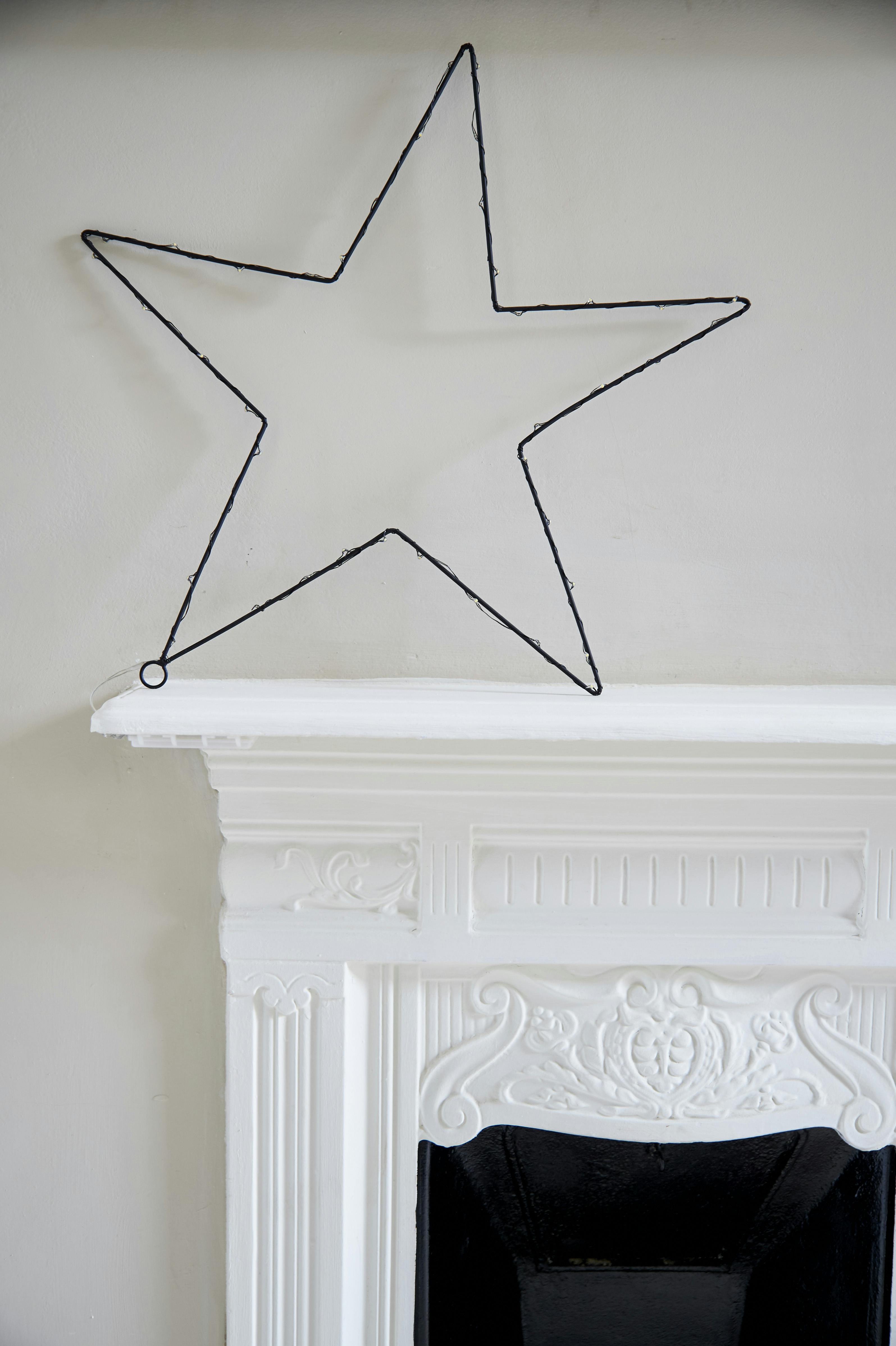 Decorative star light on ornamental fireplace in Bunk Room