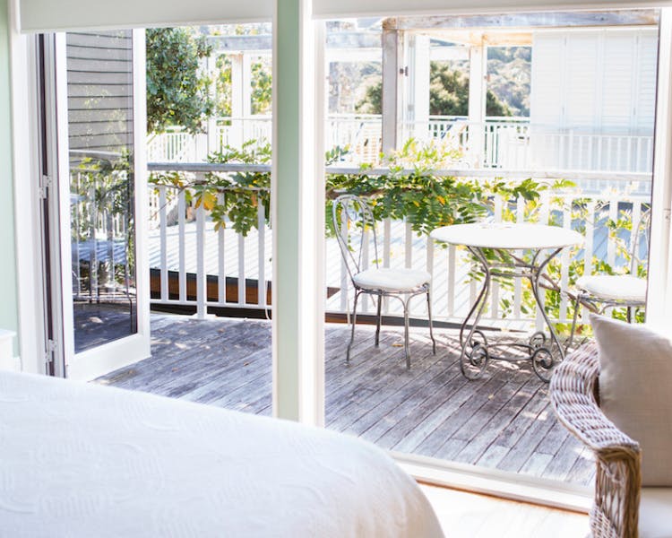 Sunny bedroom with bi-fold doors to outside private deck - Shakespeare Suite, 970 Lonely Bay Lodge