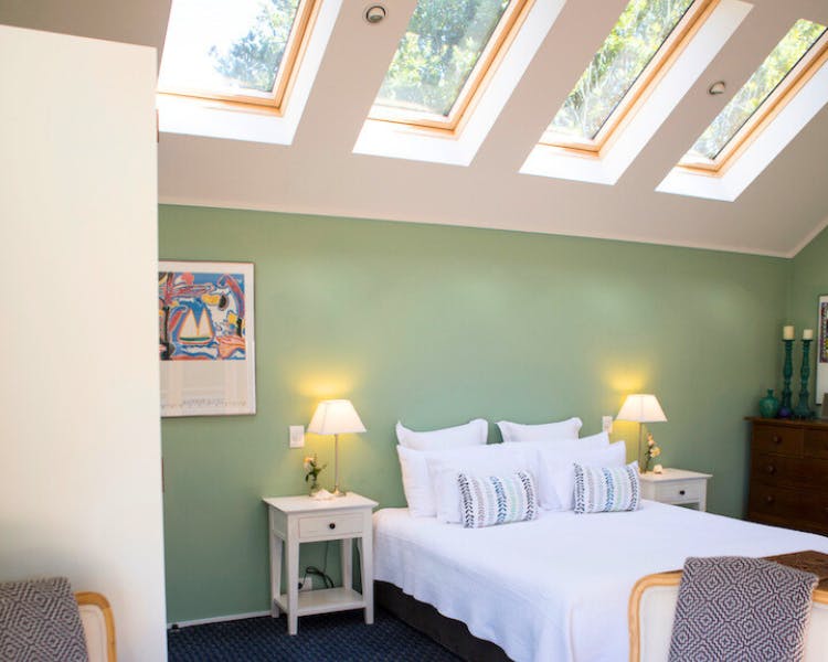 Large bedroom with indoor seating - Purangi Suite, 970 Lonely Bay Lodge