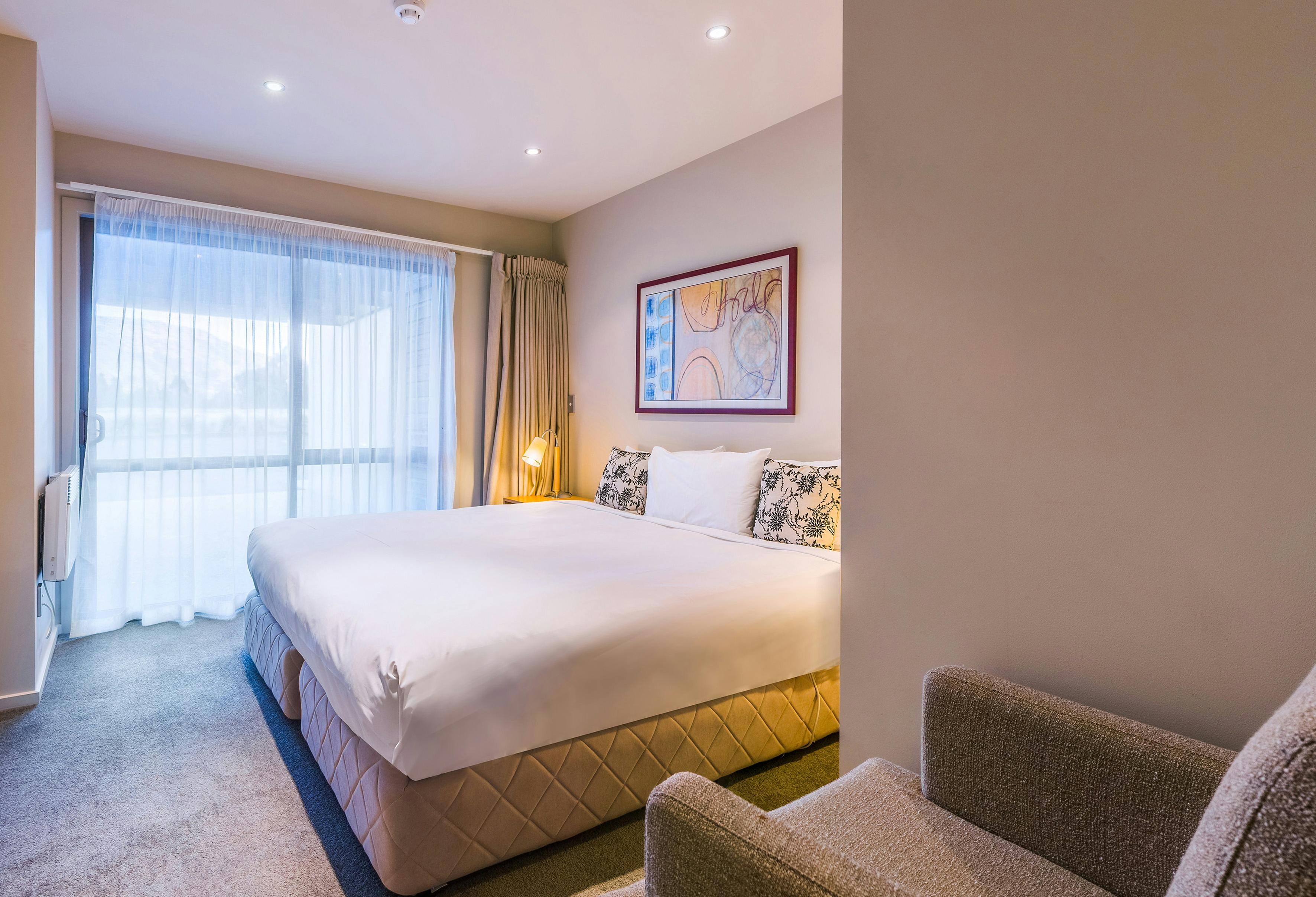 Bright and airy standard room at Oakridge Resort, featuring large windows that fill the space with natural light and offer st