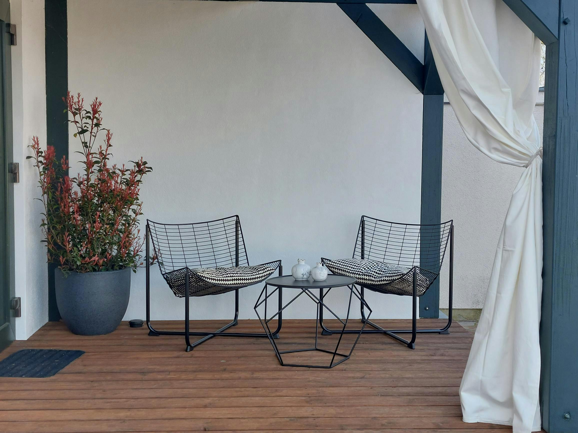 The Apple Studio front porch with chairs and table for relaxing enjoyment.