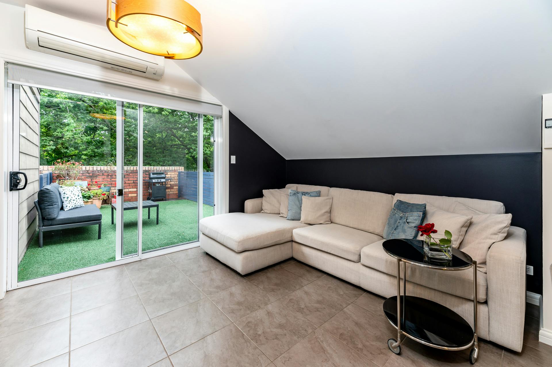 Comfy couch in lounge with large window to deck