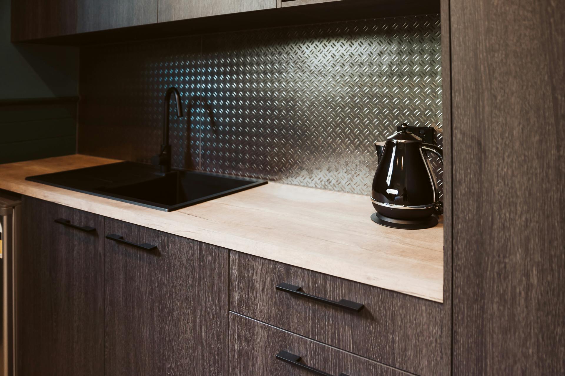 Sleek kitchenette and black kettle