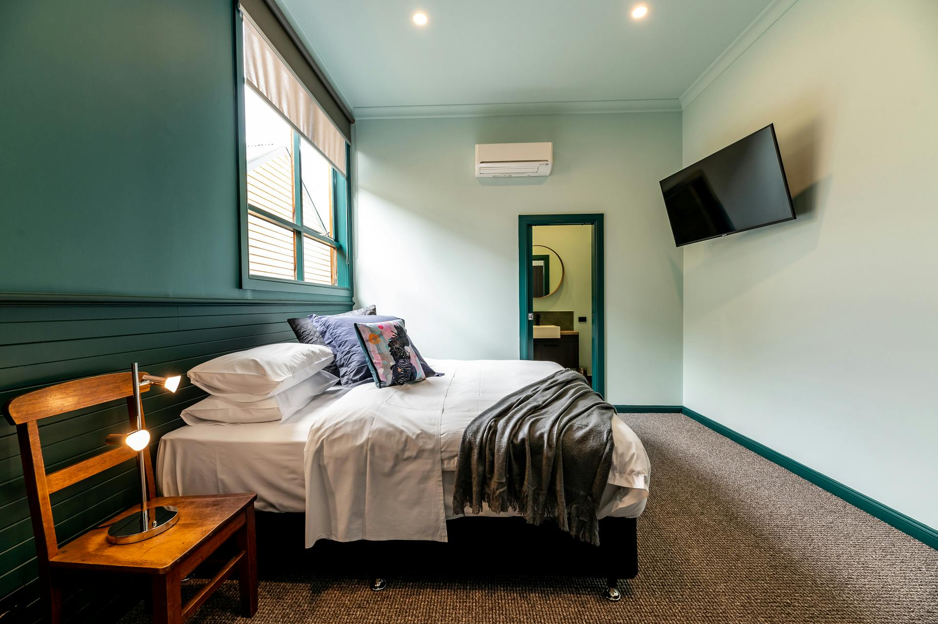 Large light filled bedroom with king size bed