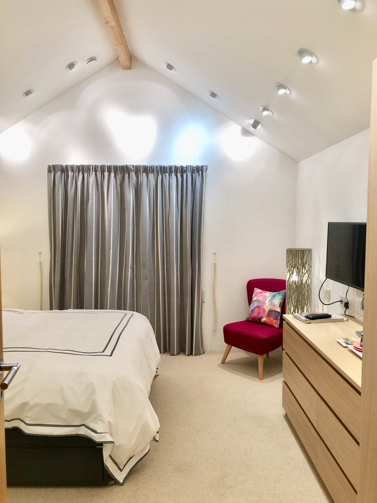 Bedroom 2 with view of vaulted ceiling and down lights