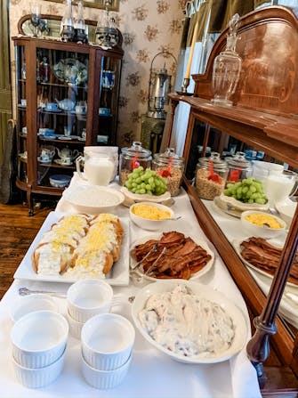 Breakfast buffet at The Victorian on Main, Eggs a la Goldenrod, bacon, fresh fruit, yogurt with berries, and cereal.