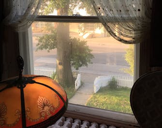 Magic hour view out of the second story window at The Victorian on Main