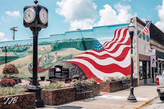 Love Thou They Land. Very large mural of the American Flag and historic buildings, Fairfield, Il
