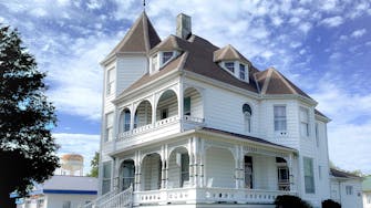 The Victorian on Main bed & breakfast, Fairfield, Il. White, 3-story Queen Anne Victorian architecture.